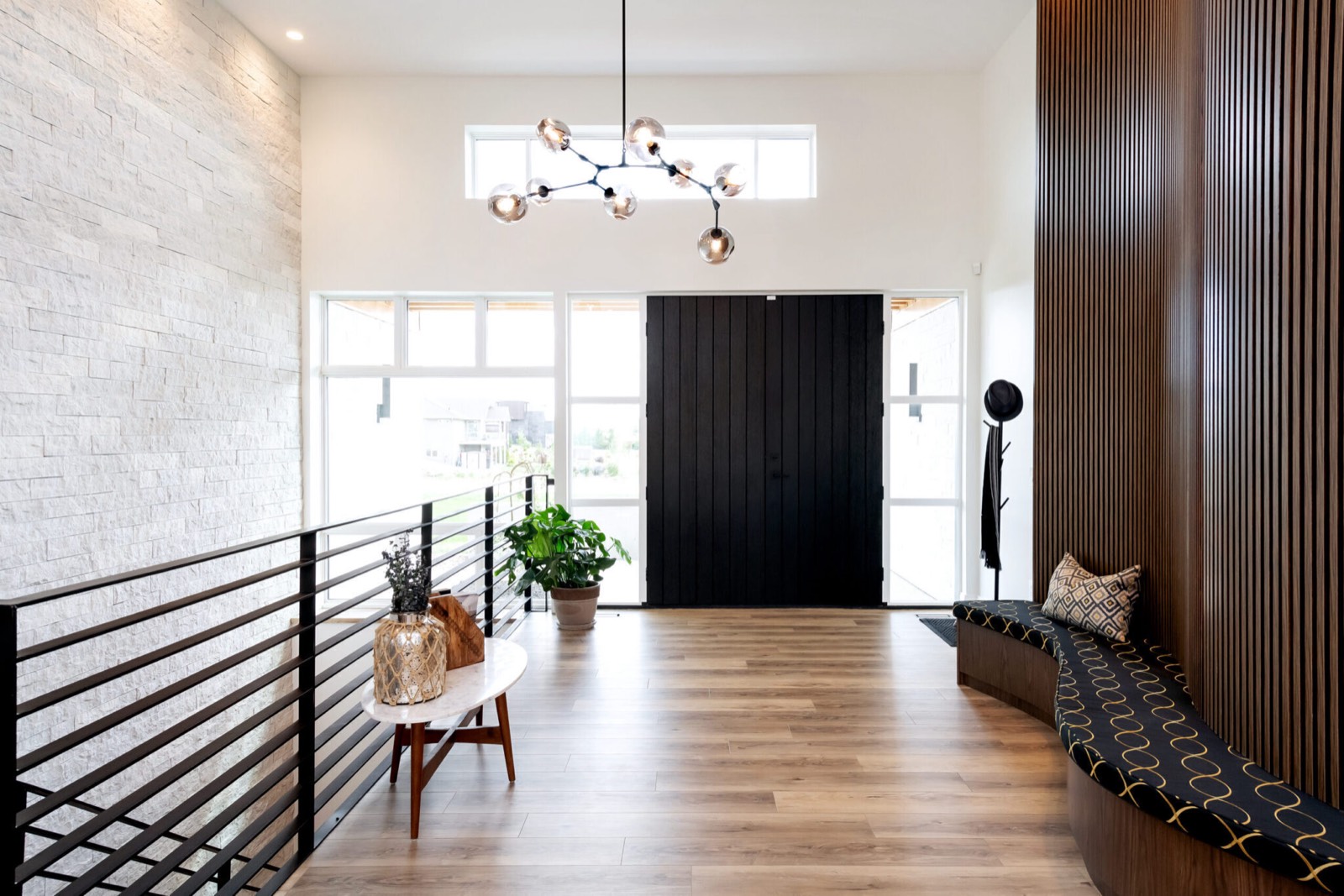 Entry hall of a Decora show home in Greenbryre, with a black front door and oak flooring