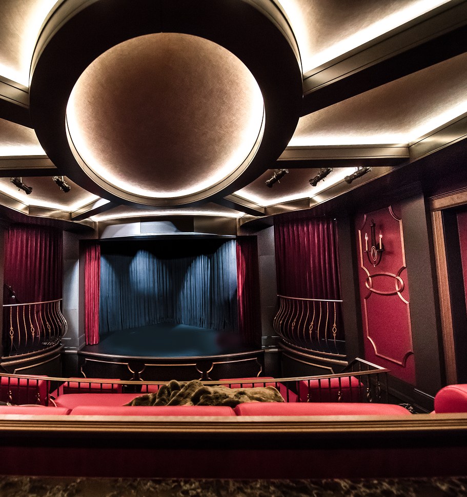 Home theatre with red seating and a circular lit ceiling